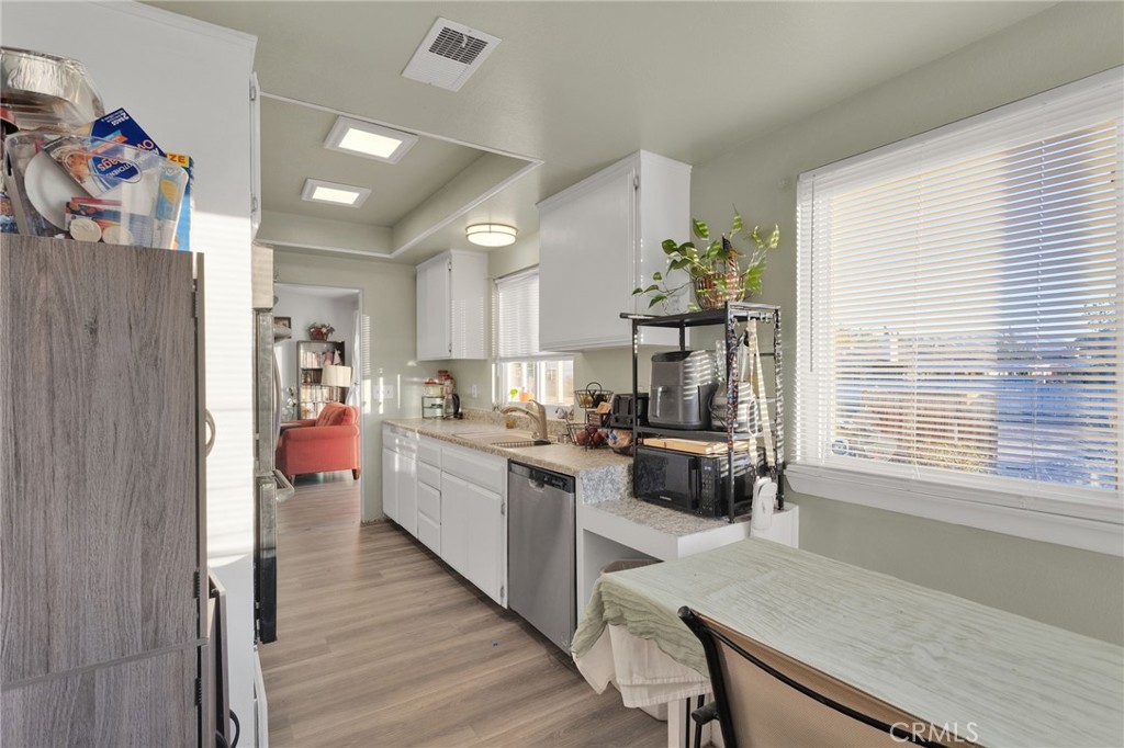13167 Olathe Road Apple Valley, CA 92308 - Photo 15 of 40 a kitchen that has a lot of cabinets a sink and appliances in it