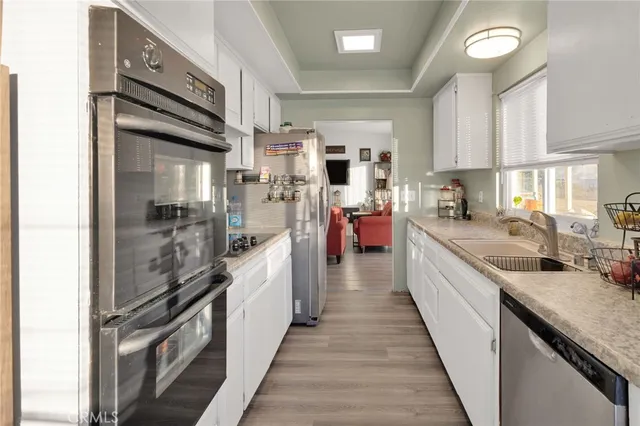 a kitchen with kitchen island granite countertop lots of counter top space and stainless steel appliances