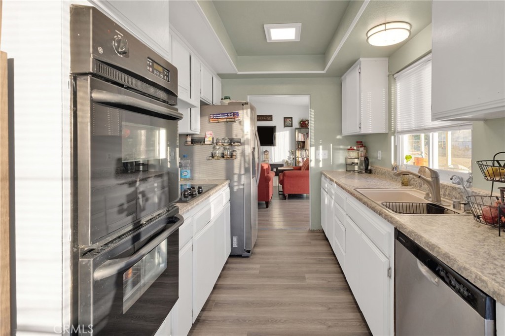 13167 Olathe Road Apple Valley, CA 92308 - Photo 16 of 40 a kitchen with kitchen island granite countertop lots of counter top space and stainless steel appliances