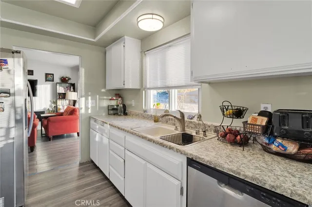 a kitchen with sink and cabinets