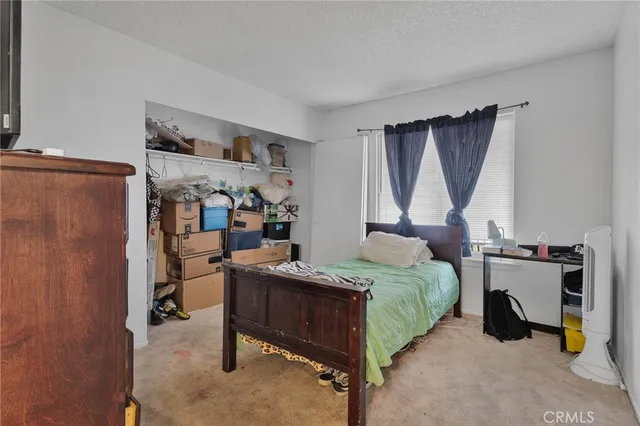 a bedroom with a bed and a desk