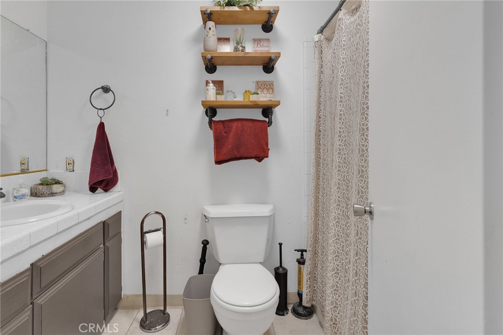 13167 Olathe Road Apple Valley, CA 92308 - Photo 21 of 40 a bathroom with a toilet sink and mirror