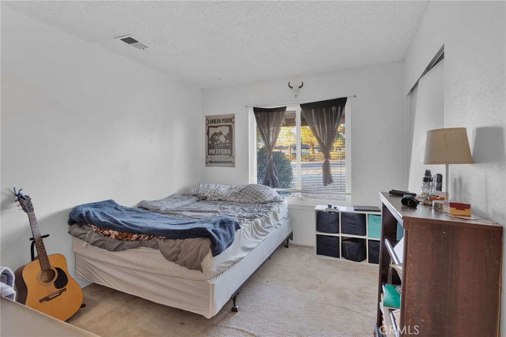 13167 Olathe Road Apple Valley, CA 92308 - Photo 22 of 40 a bedroom with a bed and a window
