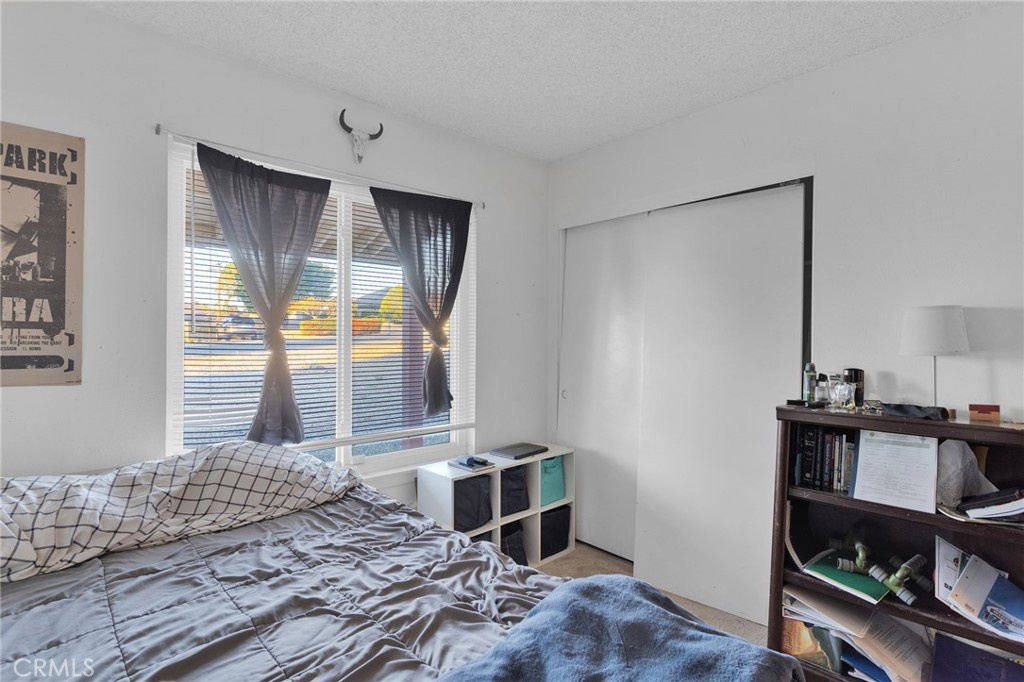 13167 Olathe Road Apple Valley, CA 92308 - Photo 23 of 40 a bedroom with a bed and a window