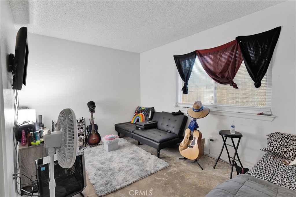 13167 Olathe Road Apple Valley, CA 92308 - Photo 24 of 40 a living room with furniture and a flat screen tv