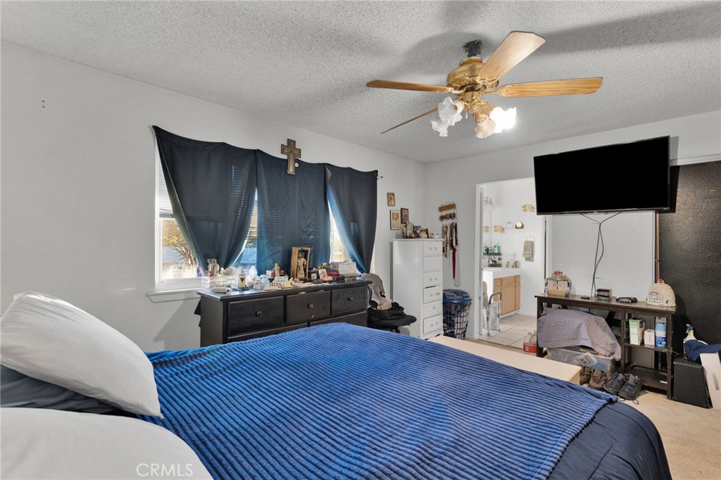 13167 Olathe Road Apple Valley, CA 92308 - Photo 28 of 40 a living room with furniture and a flat screen tv
