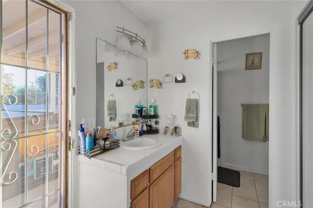 a bathroom with a sink vanity granite tub and shower