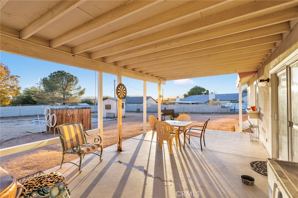 13167 Olathe Road Apple Valley, CA 92308 - Photo 32 of 40 a view of a swimming pool with a table and chairs