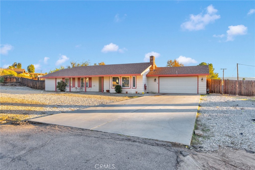 13167 Olathe Road Apple Valley, CA 92308 - Photo 39 of 40 a front view of a house with a yard and balcony