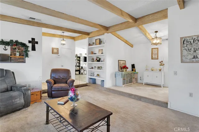 a living room with furniture and white walls