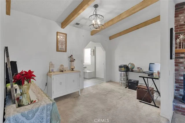 a view of a workspace with furniture and a chandelier