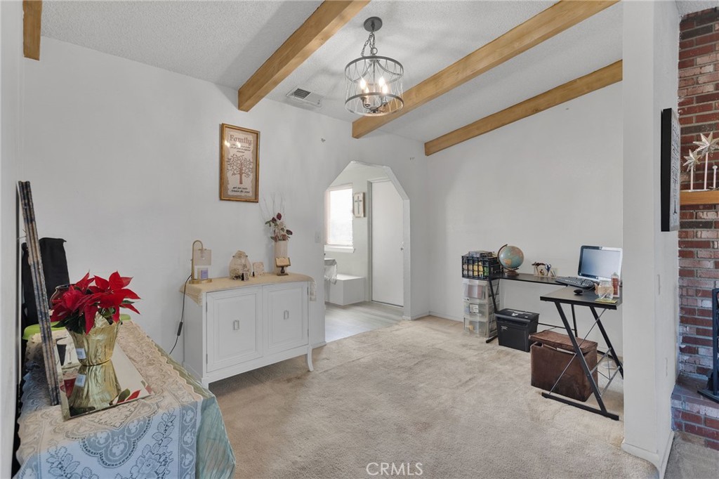 13167 Olathe Road Apple Valley, CA 92308 - Photo 7 of 40 a view of a workspace with furniture and a chandelier
