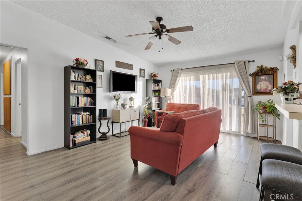 13167 Olathe Road Apple Valley, CA 92308 - Photo 8 of 40 a living room with furniture and a flat screen tv
