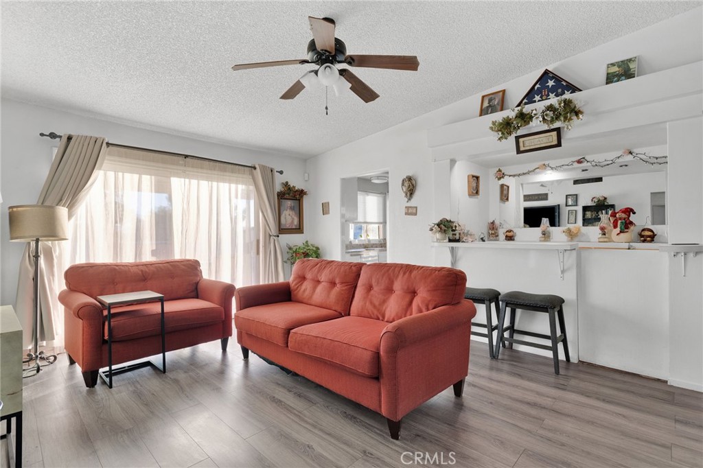 13167 Olathe Road Apple Valley, CA 92308 - Photo 9 of 40 a living room with furniture ceiling fan and a window