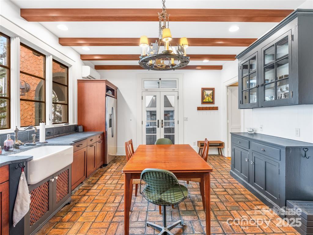 26 Sheridan Road Asheville, NC 28803 - Photo 21 of 46 a view of a dining room with furniture and chandelier