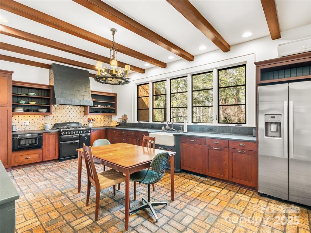26 Sheridan Road Asheville, NC 28803 - Photo 22 of 46 a kitchen with stainless steel appliances granite countertop a sink and a refrigerator
