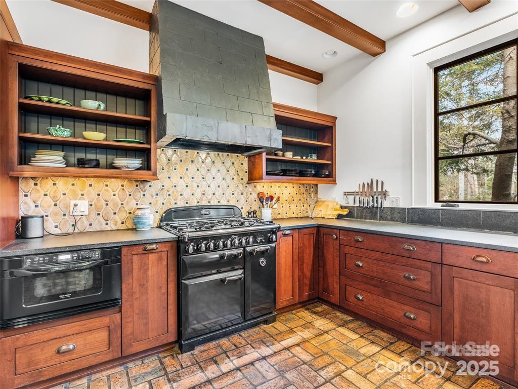 26 Sheridan Road Asheville, NC 28803 - Photo 24 of 46 a kitchen with stainless steel appliances granite countertop a stove and a sink