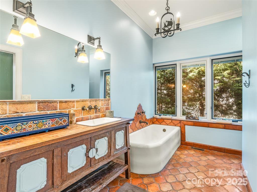 26 Sheridan Road Asheville, NC 28803 - Photo 34 of 46 a bathroom with a tub sink and mirror