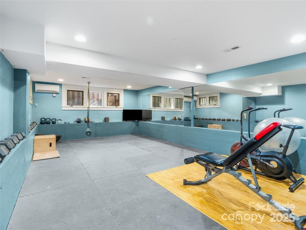 26 Sheridan Road Asheville, NC 28803 - Photo 41 of 46 a living room with furniture and a flat screen tv