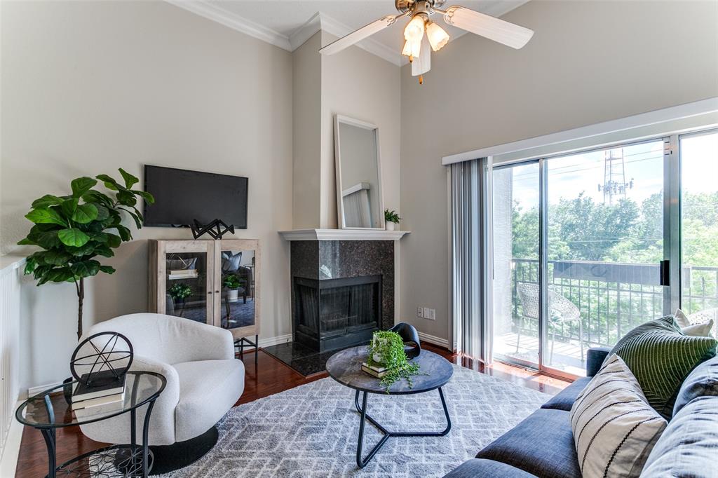 a living room with furniture a chandelier and a fireplace