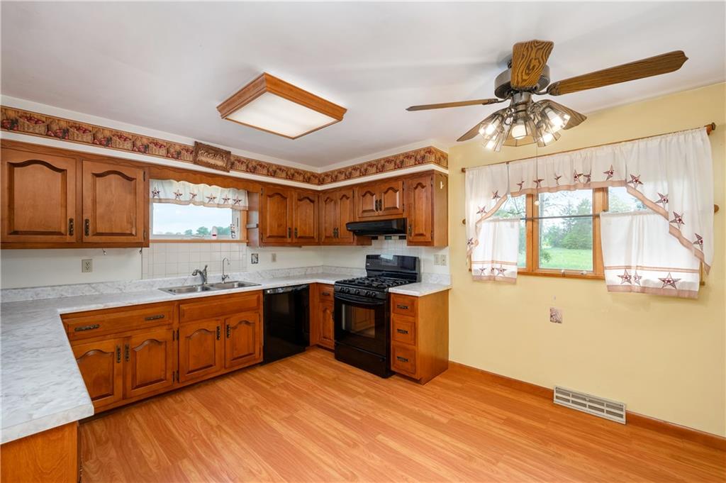 501 Bear Creek Road Sarver, PA 16055 - Photo 11 of 30 a kitchen with stainless steel appliances granite countertop a sink cabinets and wooden floor