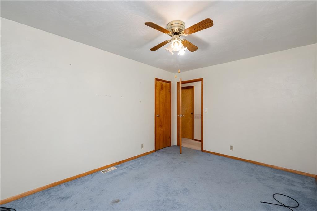 501 Bear Creek Road Sarver, PA 16055 - Photo 19 of 30 an empty room with a chandelier fan and wooden floor