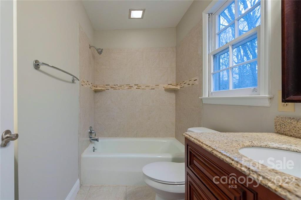 2522 Merrywood Road Charlotte, NC 28210 - Photo 12 of 21 a bathroom with a granite countertop toilet a sink and a bathtub