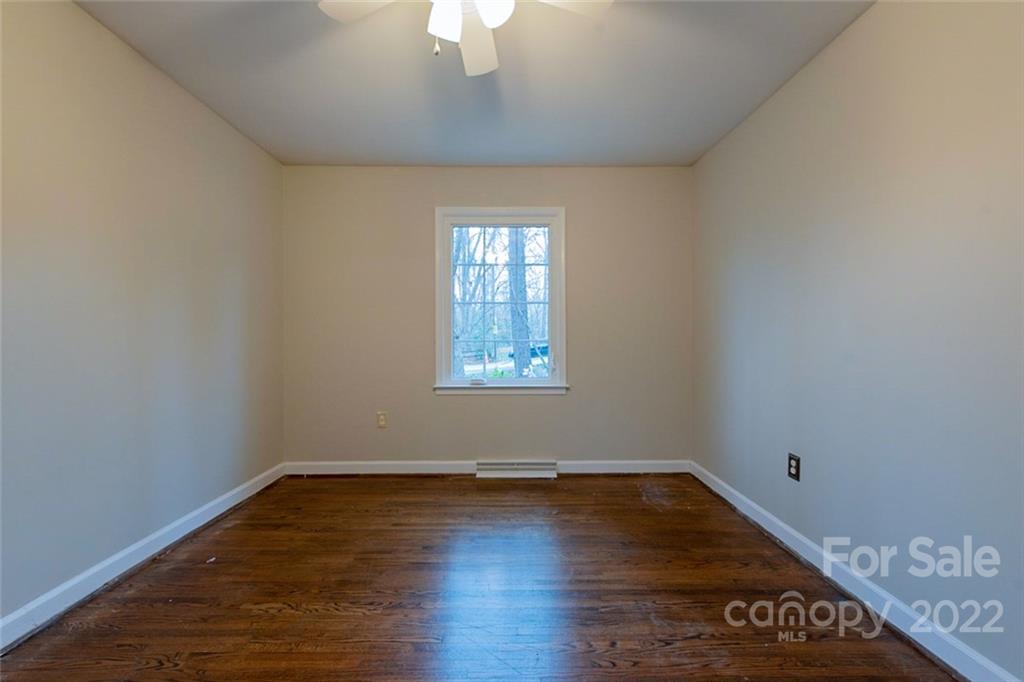 2522 Merrywood Road Charlotte, NC 28210 - Photo 13 of 21 wooden floor in an empty room with a window