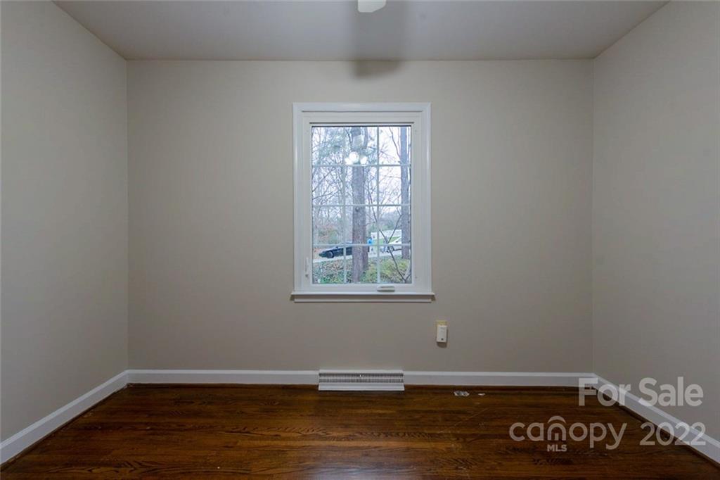 2522 Merrywood Road Charlotte, NC 28210 - Photo 14 of 21 a view of an empty room with wooden floor and a window
