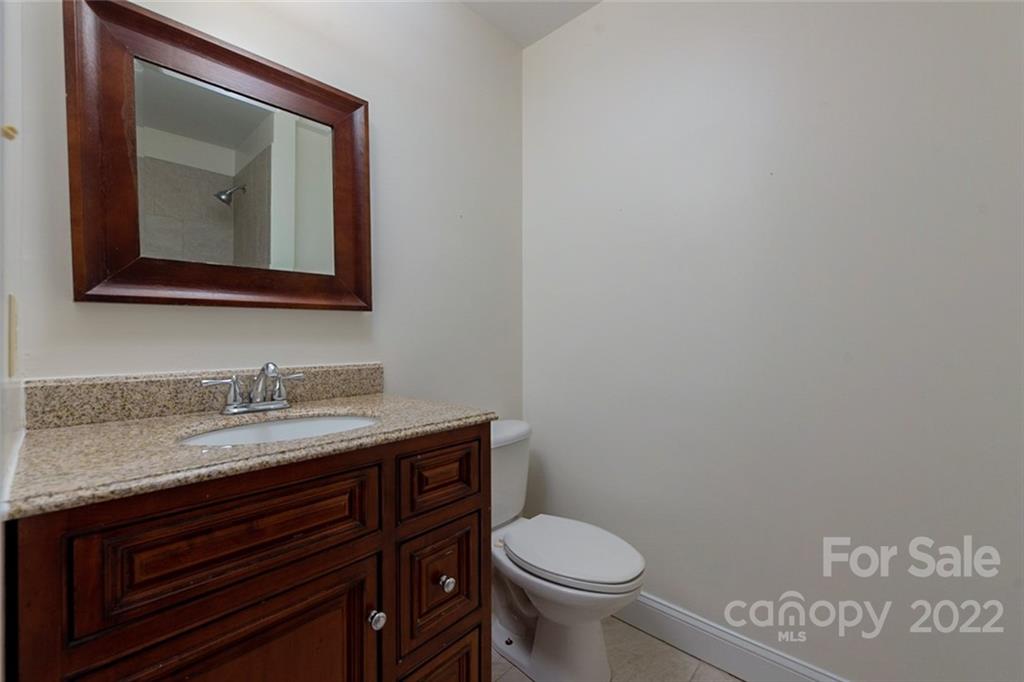 2522 Merrywood Road Charlotte, NC 28210 - Photo 15 of 21 a bathroom with a toilet sink and mirror