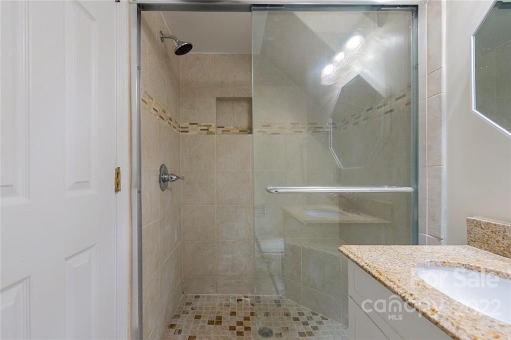2522 Merrywood Road Charlotte, NC 28210 - Photo 6 of 21 a bathroom with a granite countertop shower a sink and a mirror
