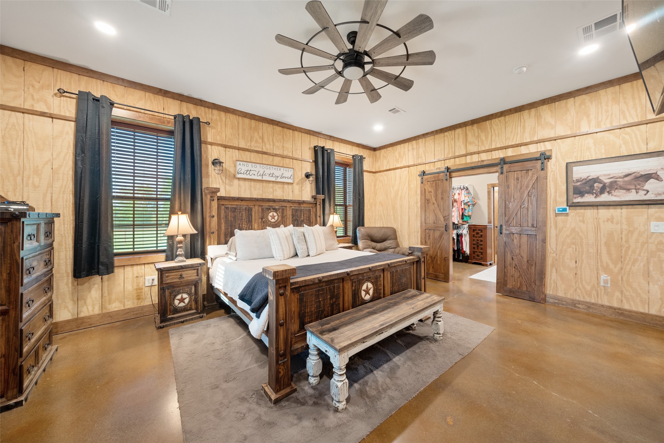 1402 Eagle Ferry Road Anahuac, TX 77514 - Photo 30 of 48 a spacious bedroom with a bed and a chandelier