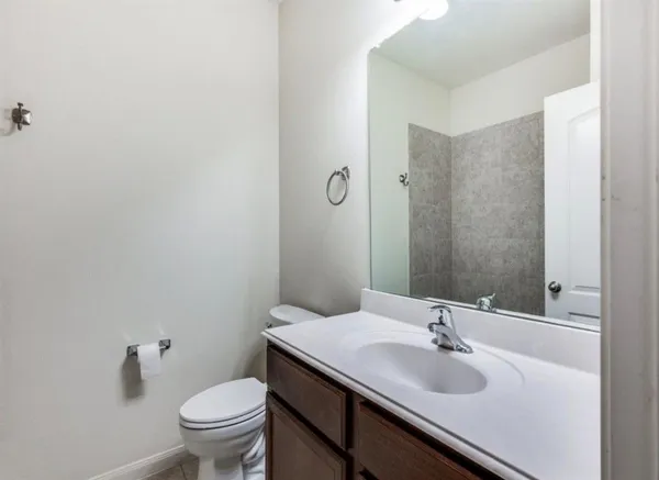 a bathroom with a sink toilet and mirror