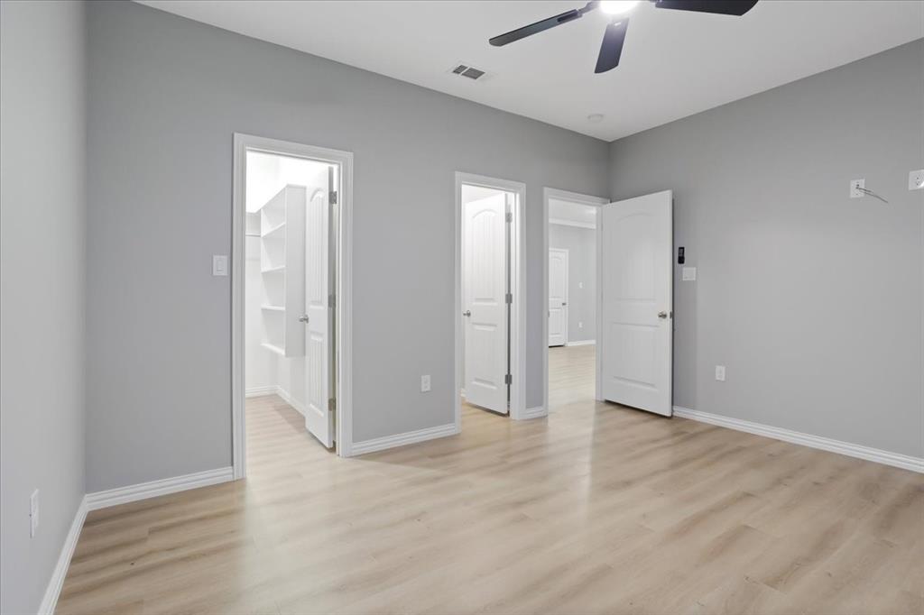215 East Nelson Street Denison, TX 75021 - Photo 15 of 27 wooden floor in an empty room with a bathroom
