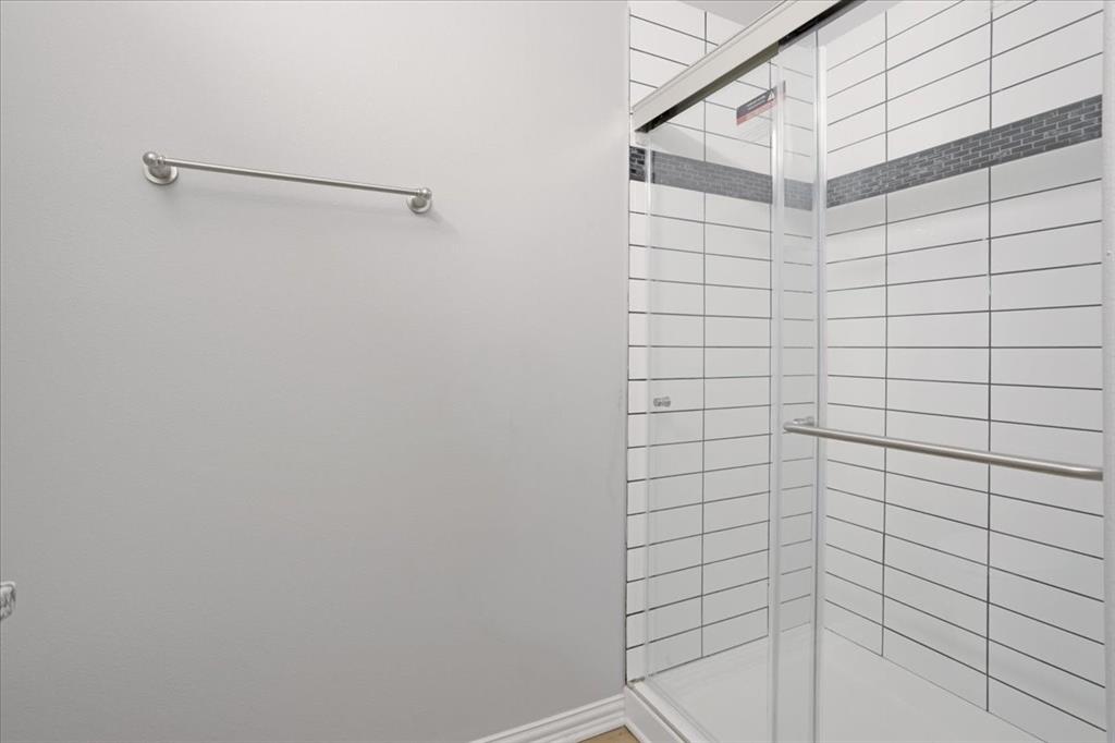 215 East Nelson Street Denison, TX 75021 - Photo 17 of 27 a bathroom with a shower