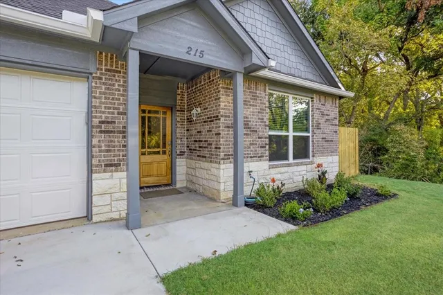 front view of a house with potted plants