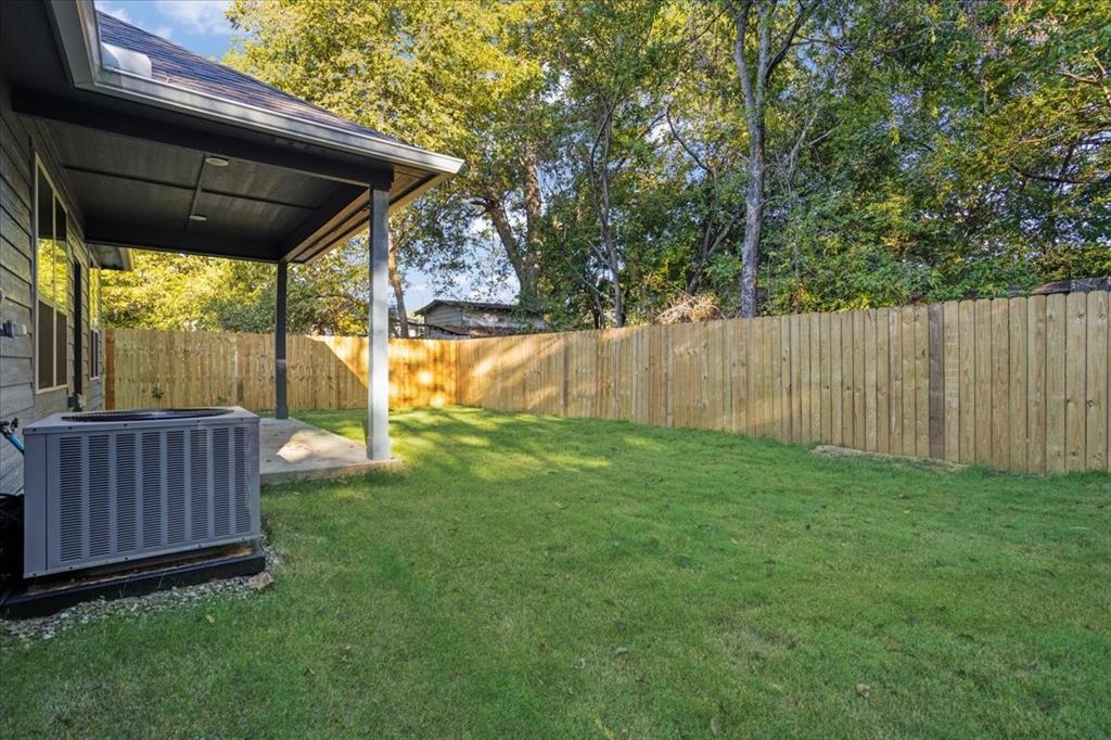 215 East Nelson Street Denison, TX 75021 - Photo 25 of 27 a view of backyard with small cabin and wooden fence