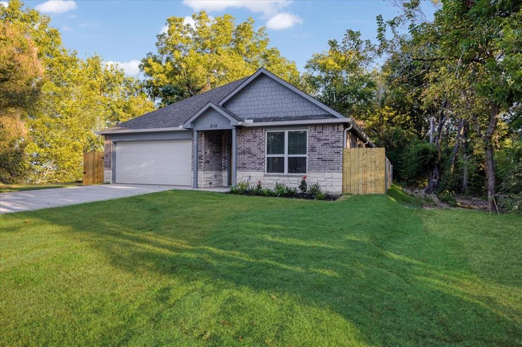 215 East Nelson Street Denison, TX 75021 - Photo 27 of 27 a view of a house with yard and a garden