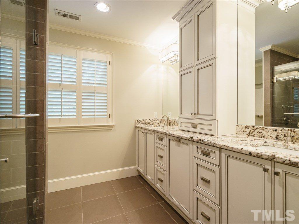 3116 Eton Road Raleigh, NC 27608 - Photo 16 of 25 a bathroom with a granite countertop sink and a mirror