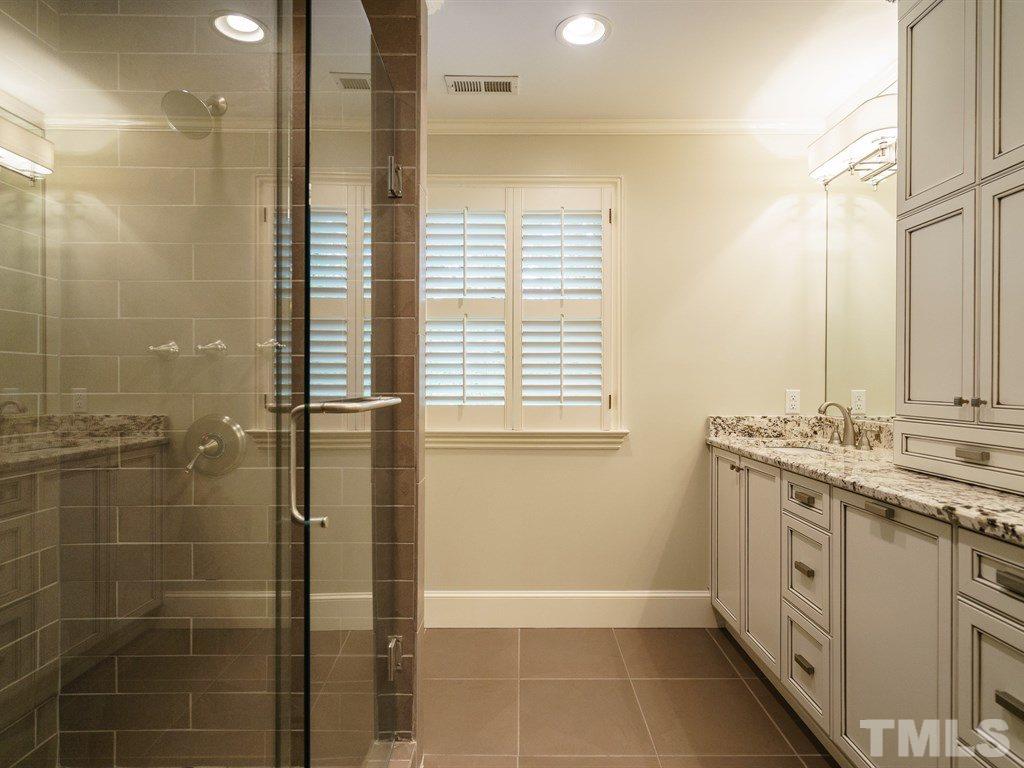 3116 Eton Road Raleigh, NC 27608 - Photo 17 of 25 a bathroom with a granite countertop sink a toilet and shower