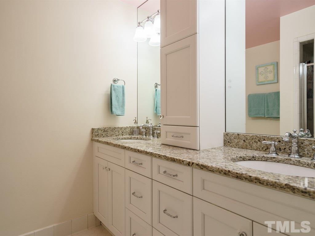 3116 Eton Road Raleigh, NC 27608 - Photo 19 of 25 a bathroom with a granite countertop sink and a mirror