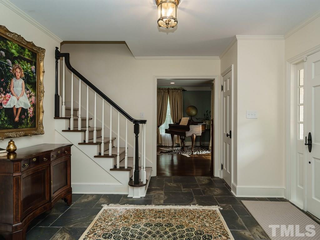 3116 Eton Road Raleigh, NC 27608 - Photo 3 of 25 a view of a hallway view with living room and wooden floor