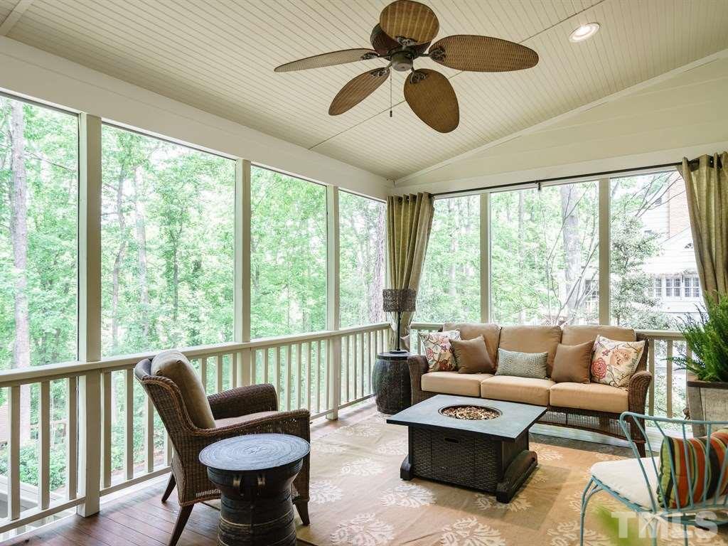 3116 Eton Road Raleigh, NC 27608 - Photo 23 of 25 a living room with furniture and a floor to ceiling window