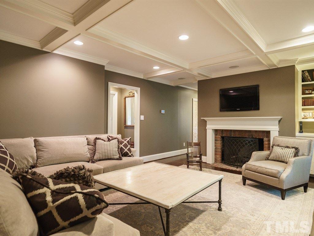 3116 Eton Road Raleigh, NC 27608 - Photo 7 of 25 a living room with furniture a fireplace and a flat screen tv