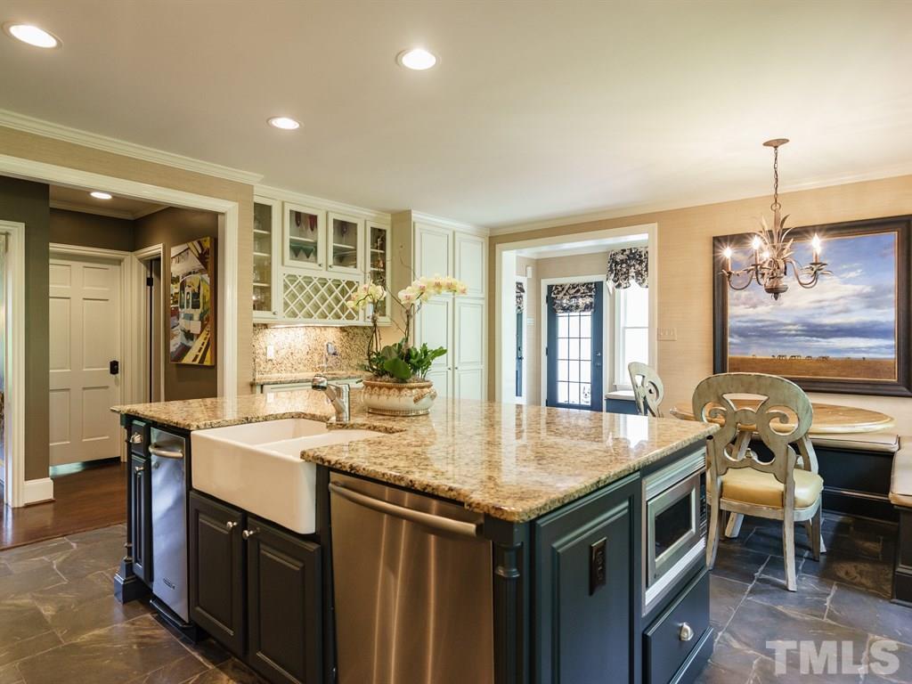 3116 Eton Road Raleigh, NC 27608 - Photo 9 of 25 a kitchen with a sink stove and cabinets