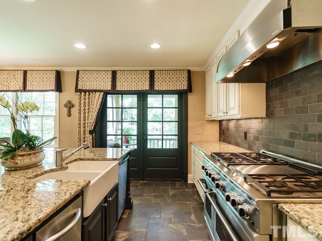 3116 Eton Road Raleigh, NC 27608 - Photo 10 of 25 a kitchen with a stove and a sink
