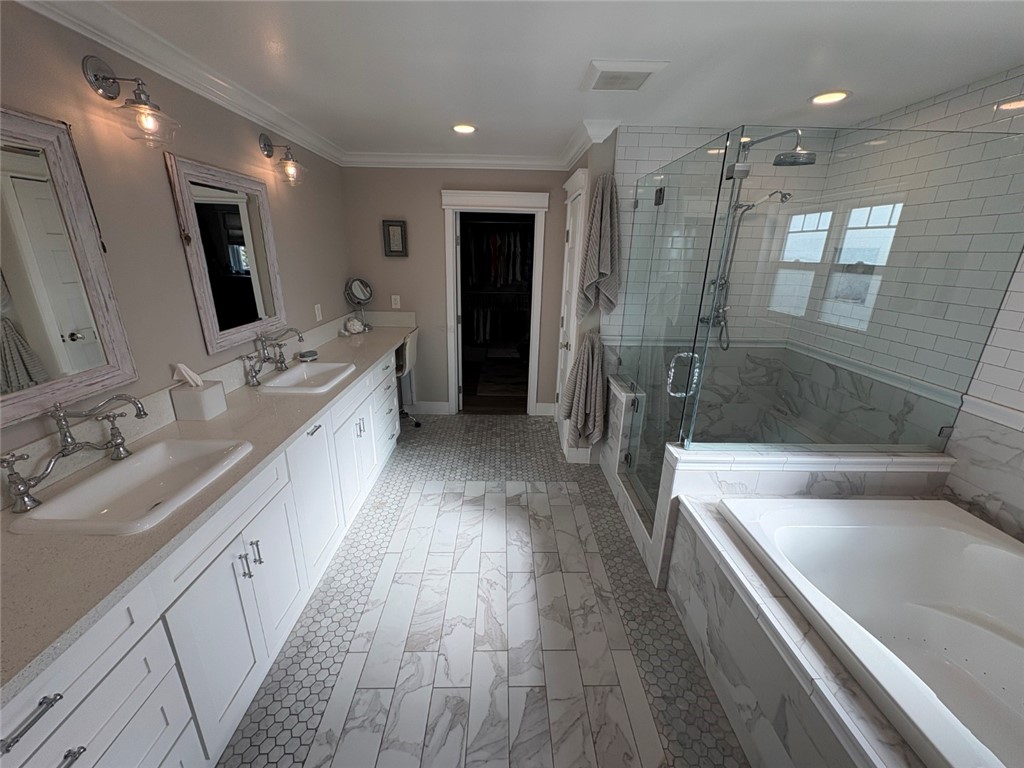 15471 Victoria Huntington Beach, CA 92647 - Photo 18 of 37 a large bathroom with a double vanity sink a large mirror and shower