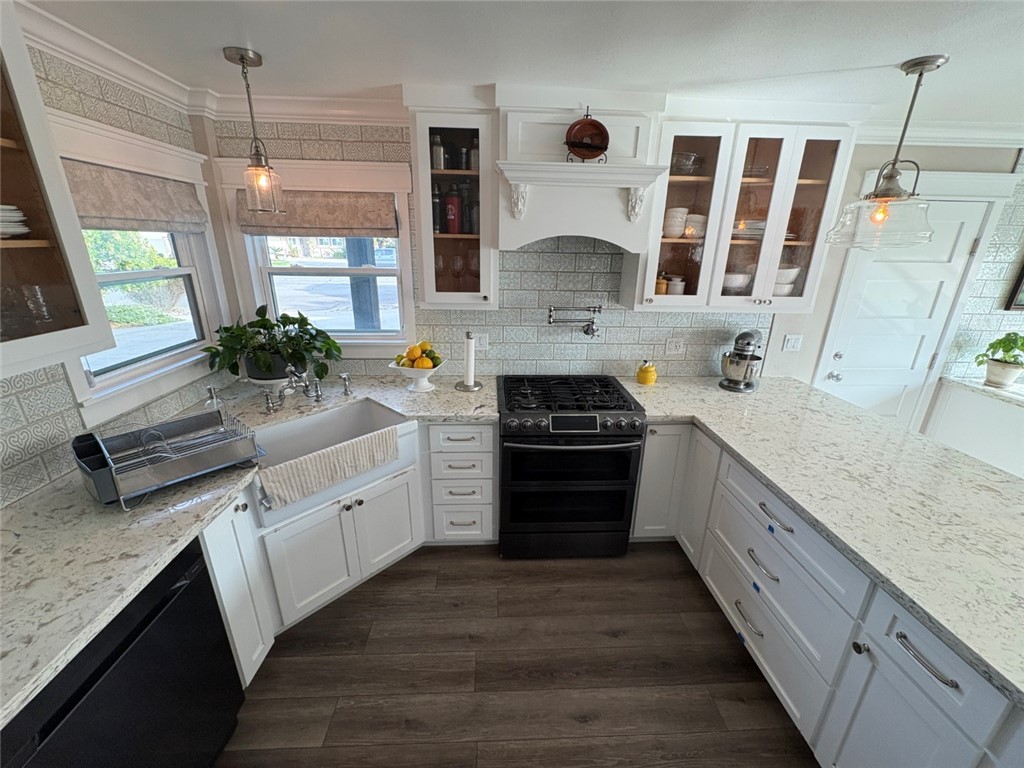 15471 Victoria Huntington Beach, CA 92647 - Photo 3 of 37 a kitchen with stainless steel appliances a stove a sink and a refrigerator