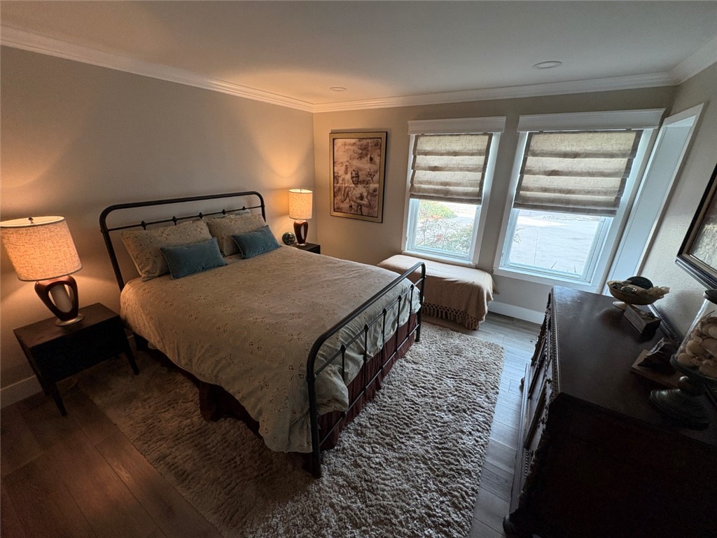 15471 Victoria Huntington Beach, CA 92647 - Photo 31 of 37 a bedroom with a bed and wooden floor