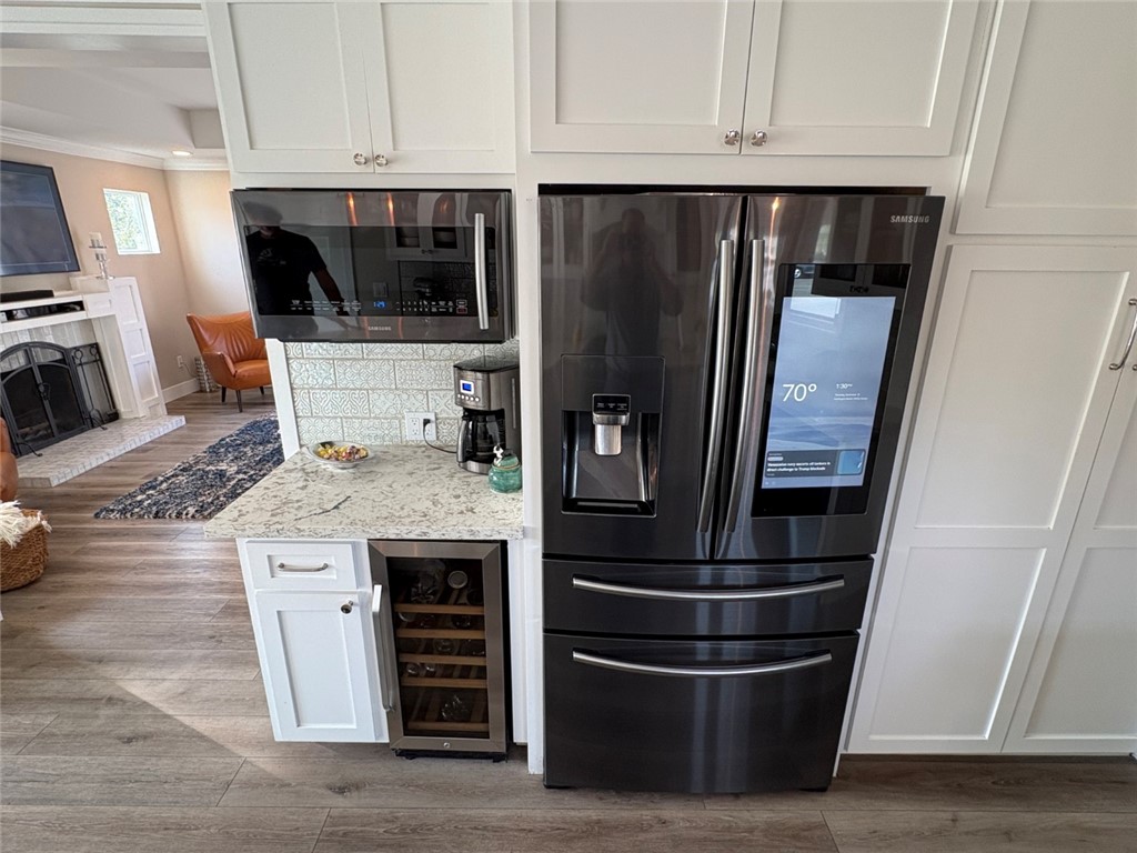 15471 Victoria Huntington Beach, CA 92647 - Photo 8 of 37 a kitchen with stainless steel appliances and wooden cabinets